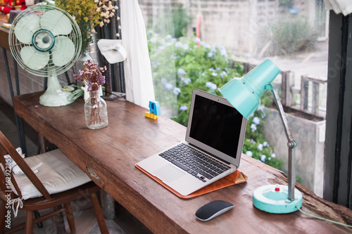 offee shop scene, laptop and lamp, by the window photo