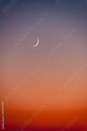 Crescent moon at sunset over the sea in Cyprus