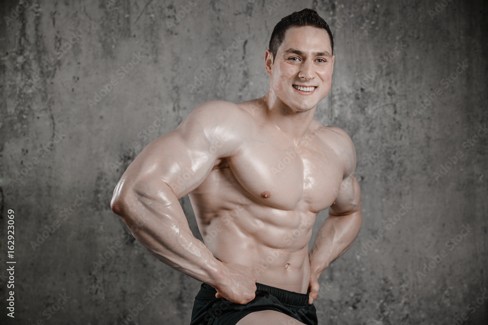 Fototapeta premium Brutal strong athletic men pumping up muscles
