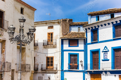 Blue houses and street light at the market square of Xativa © venemama