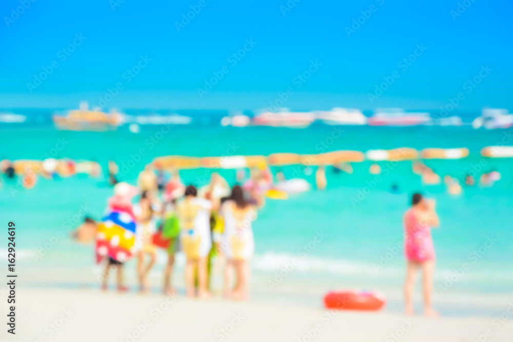 Blur image of people in colorful clothes at the beach