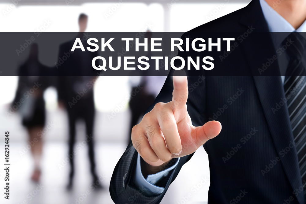 Businessman hand touching ASK THE RIGHT QUESTIONS tab on virtual screen Businessman hand touching ASK THE RIGHT QUESTIONS tab on virtual screen