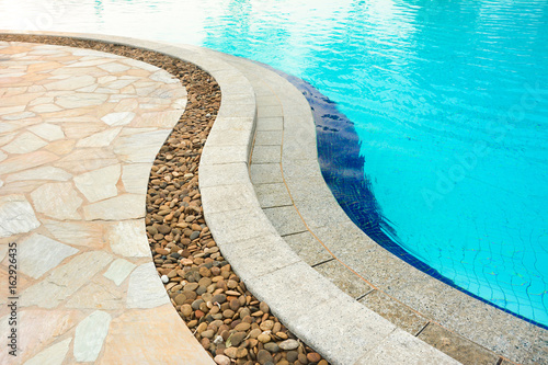 Curved swimming pool edge, made of stones