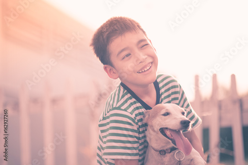 Quadro su tela Little boy walking outside with dog jack russel summer time