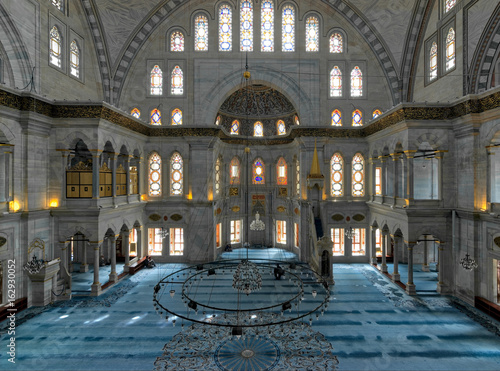 Interior of Nuruosmaniye Mosque, an Ottoman Baroque style mosque completed in 1755, with a huge dome & many colored stained glass windows located in Shemberlitash, Fatih, Istanbul, Turkey photo