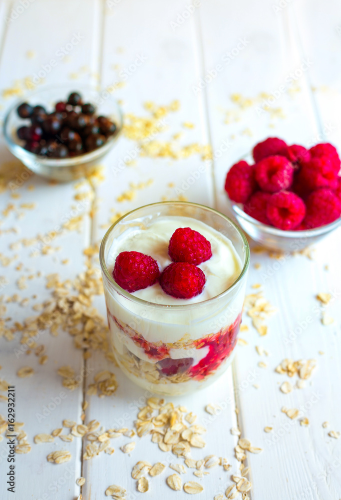 Dessert with berries of raspberries and blueberries on a wooden background Dessert with berries of raspberries and blueberries on a wooden background