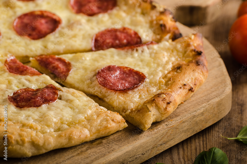 Rustic pizza with tomato, cheese, salami