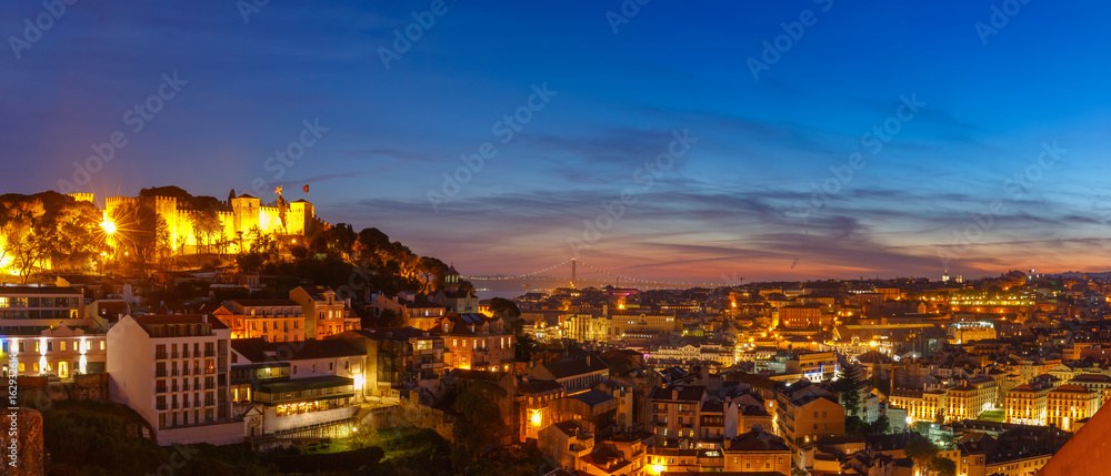 Panorama with Castle of Sao Jorge, the historical centre of Lisbon, Tagus River and 25 de Abril Bridge during evening blue hour, Lisbon, Portugal