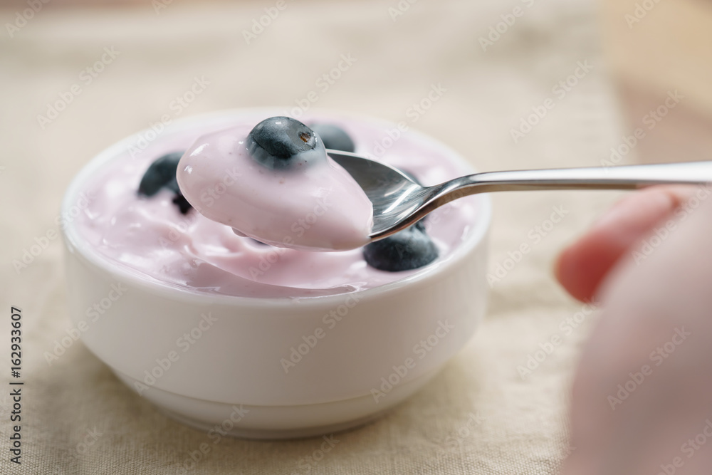 pov teen girl hand eating organic blueberry yogurt pov teen girl hand eating organic blueberry yogurt