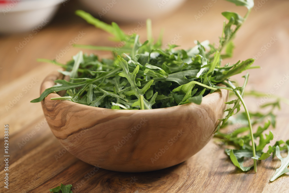 fresh green rocket salad arugula leaves in bowl