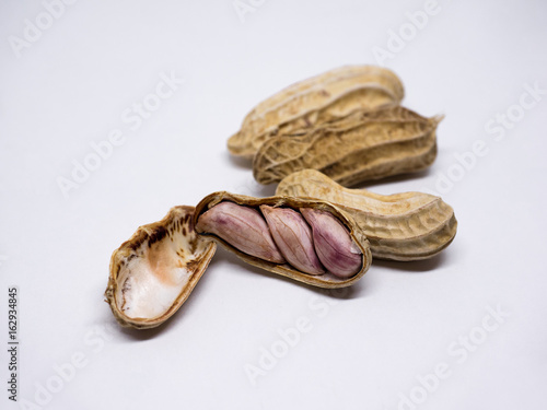 Fresh Peanuts in closeup. Peanuts in shell and peeled isolated on white background.