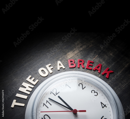 Wall clock and wording " TIME BREAK " on wooden with with Text Space