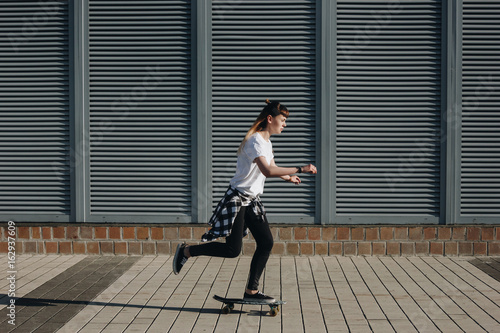 Hipster girl riding skate board © Iryna
