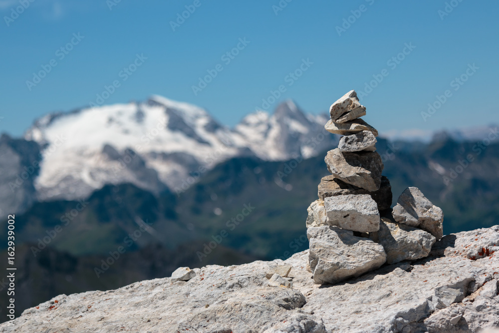 Stones Piled on Each Other and Mountain Ridge in Italian Dolomites Alps in Summer Time in Background Stones Piled on Each Other and Mountain Ridge in Italian Dolomites Alps in Summer Time in Background