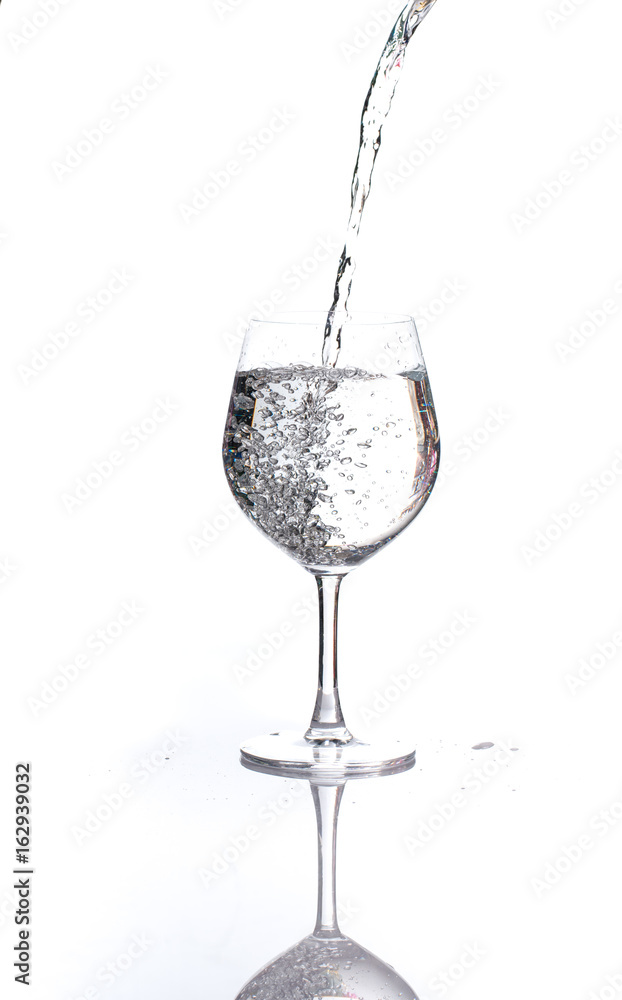 pouring water into a glass wine on white background pouring water into a glass wine on white background