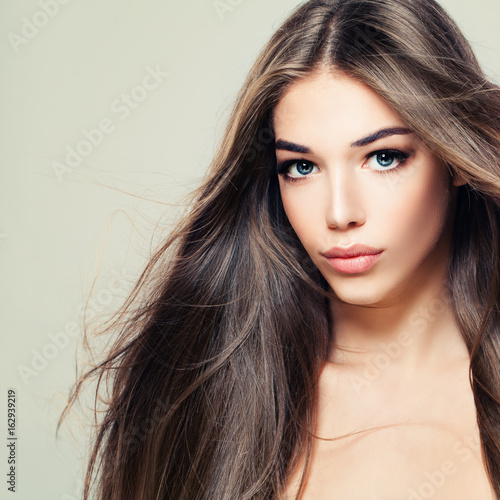 Fashion Beauty Portrait of Cute Woman with Long Brown Hair. Makeup, Hairstyle and Cute Face. Beauty Salon Background