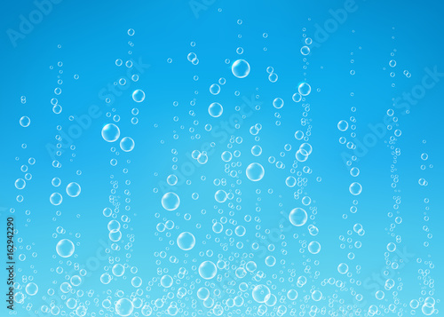 Transparent  fizzing air bubbles on blue background.