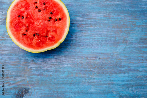 Slices of ripe watermelon on a blue countertop