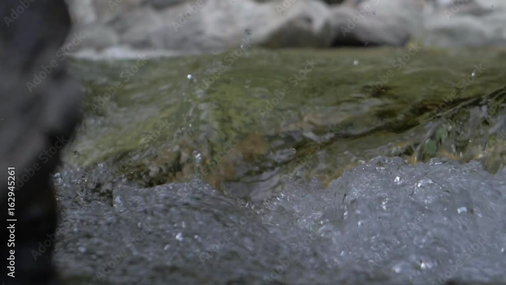 Water in a mountain river in slow motion video. Water in a mountain river in slow motion video.