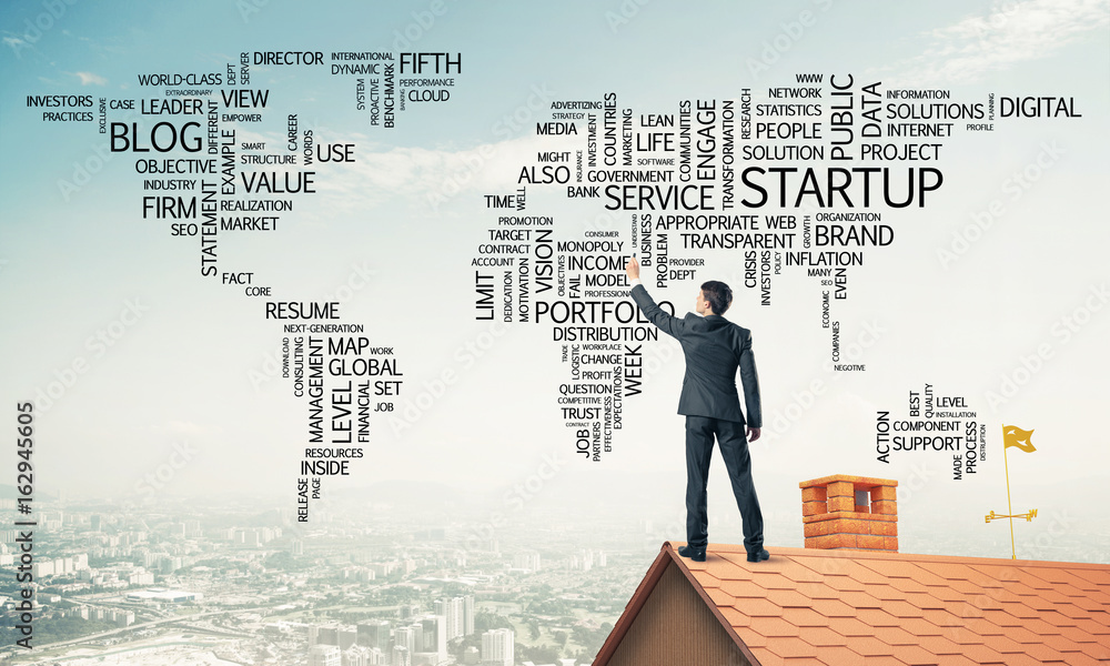 Businessman on brick roof draw world map as concept of globaliza Businessman on brick roof draw world map as concept of globaliza