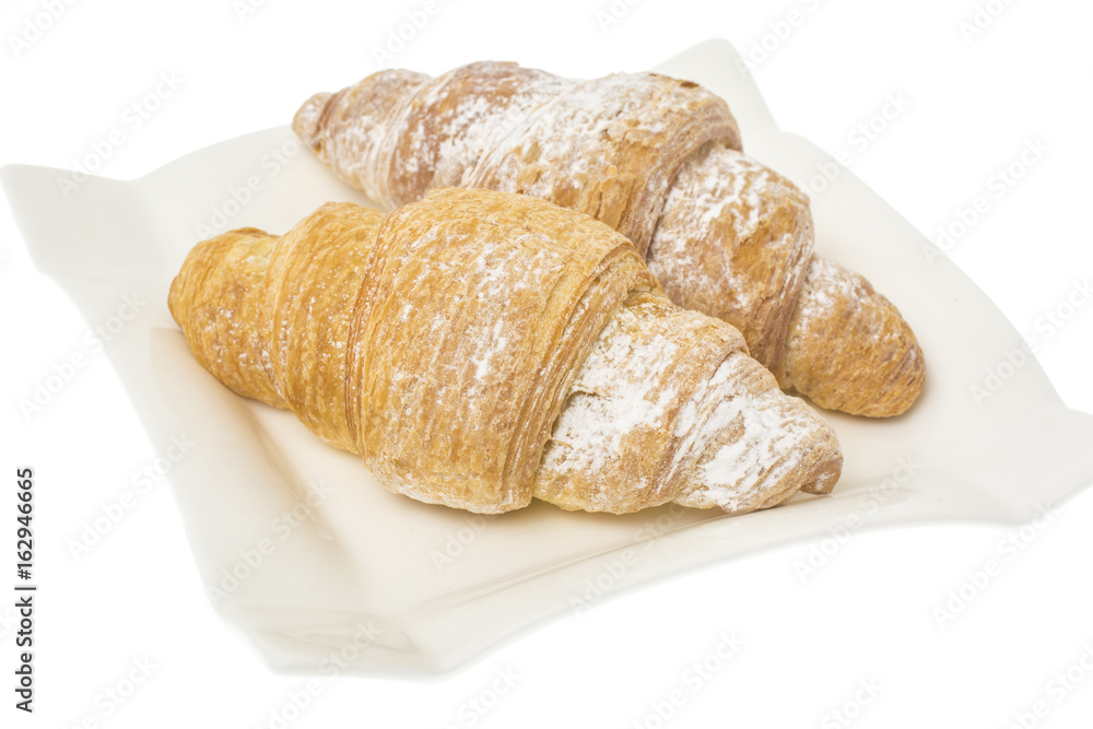 Two croissants on plate on white background. 