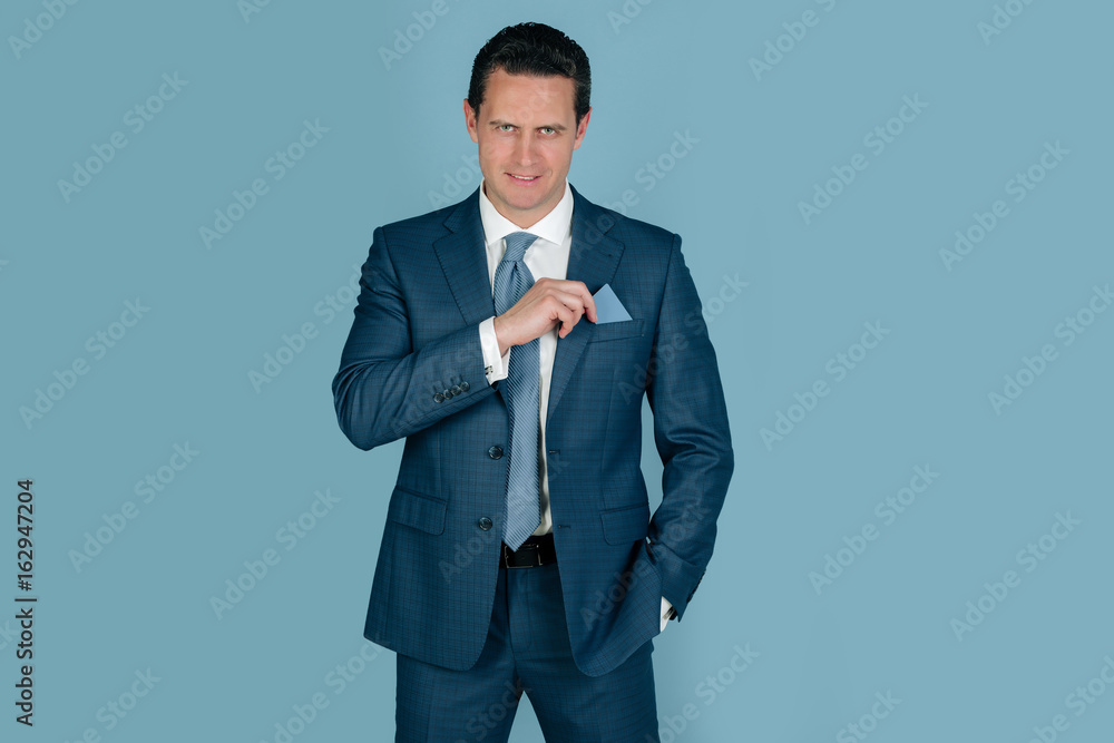 man smiling with business or bank card in pocket man smiling with business or bank card in pocket