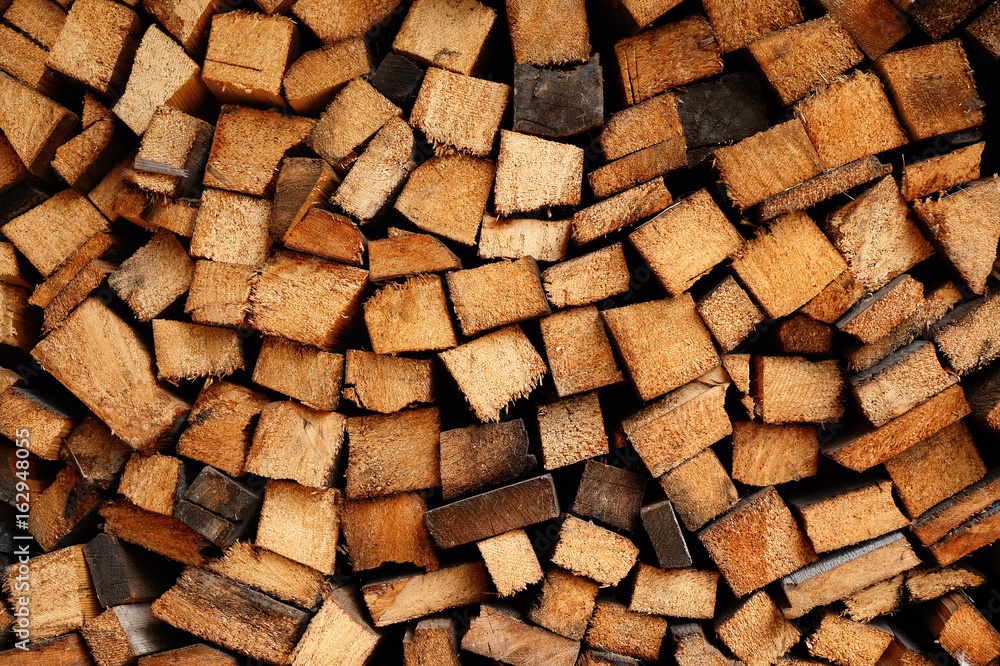 Carefully laid logs of firewood. Background Carefully laid logs of firewood. Background
