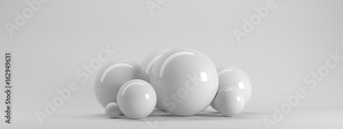 3d rendering of several sized reflected spheres inside a white studio © Archmotion.net