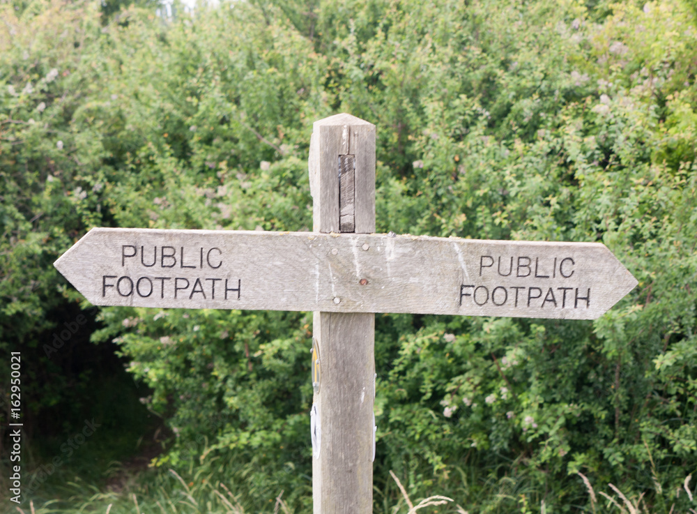 Stock Photo - double wooden post public footpath sign outside leading way