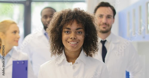 Young African American Scientist Girl With Team Of Researchers In Modern Laboratory Happy Smiling Diverse Men And Women Group Slow Motion 60