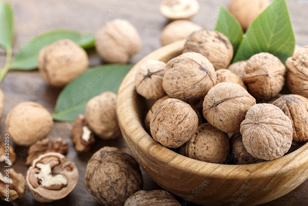 Inshell walnuts on a wooden background Inshell walnuts on a wooden background