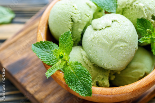 Balls mint ice cream and mint leaves closeup. photo