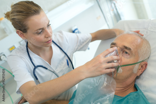 adult male patient in the hospital with oxygen mask photo