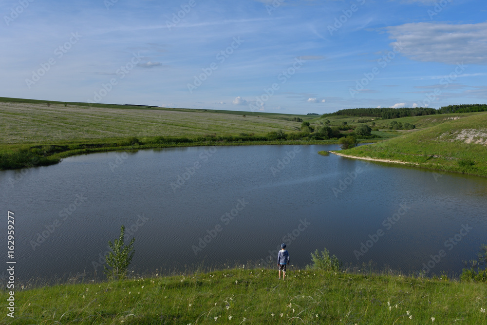 The boy is joyful and runs to the river The boy is joyful and runs to the river