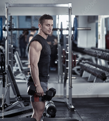 Athletic man with dumbbells