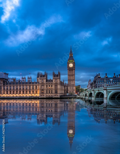 View of the Houses of Parliament and Westminster Bridge in London after duks with clear reflection