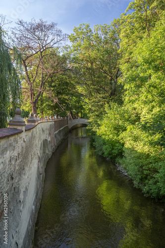 Bridge  water canal and lush trees on the Kampa Island in Prague  Czech Republic.