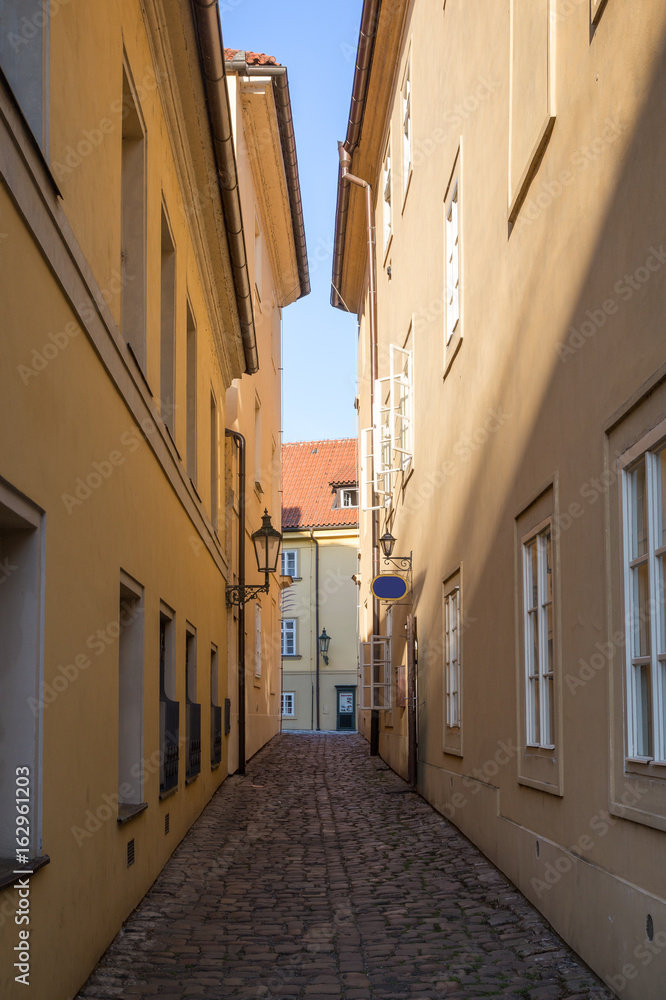 Narrow and empty alley or pedestrian street on the Kampa Island in Prague, Czech Republic.