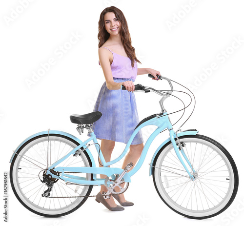 Beautiful young woman with bicycle on white background © Africa Studio