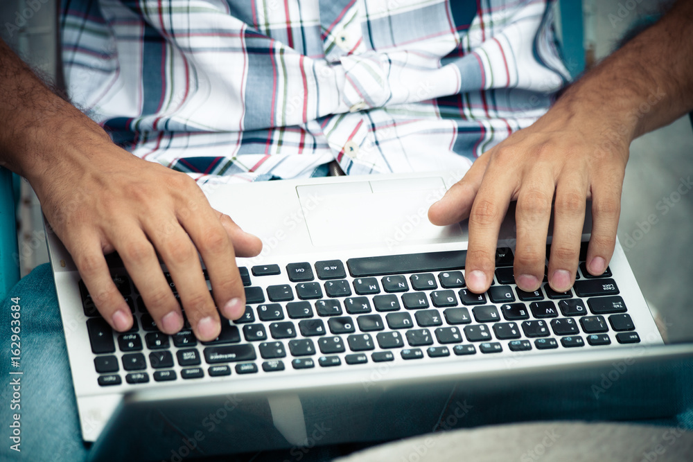 man with laptop at his lap working online outdoor shot man with laptop at his lap working online outdoor shot