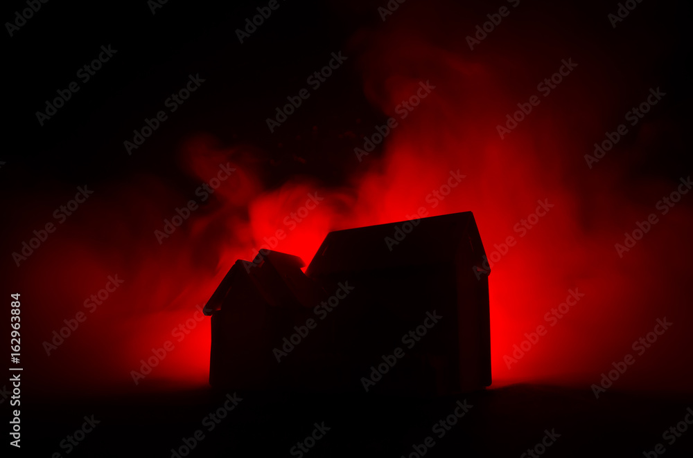 Obraz premium Old house with a Ghost in the moonlit night or Abandoned Haunted Horror House in fog. Old mystic villa with surreal big full moon. Horror concept.