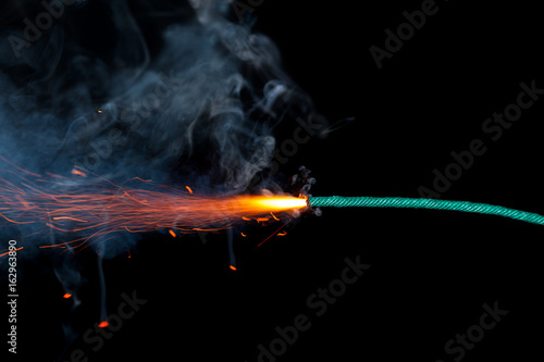 Fuse burning on black background isolated