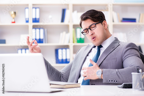 Businessman playing virtual guitar in office