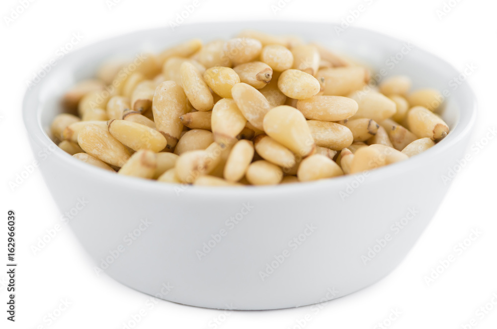 Portion of Pine Nuts isolated on white Portion of Pine Nuts isolated on white