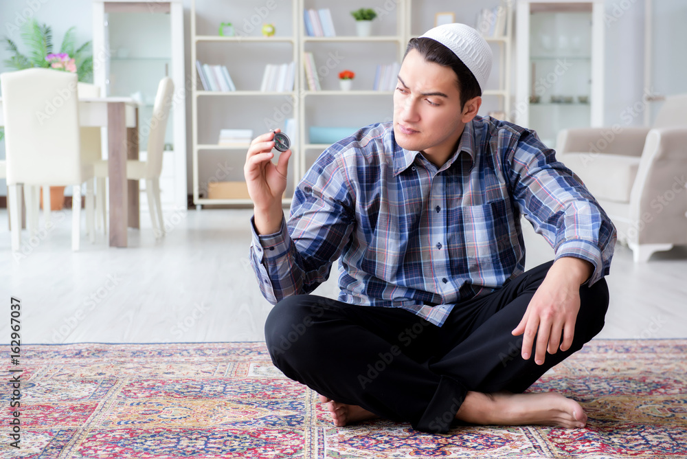 Fototapeta premium Muslim man praying at home