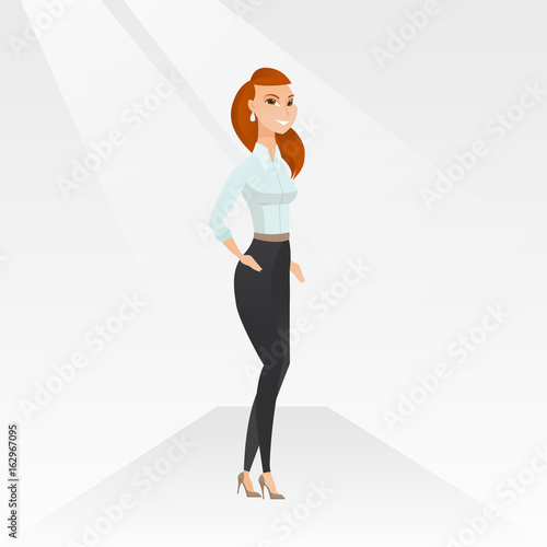 Woman posing on catwalk during fashion show.