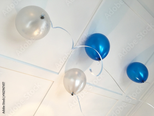Blue and white party balloon on ceiling © Rafael Ben-Ari
