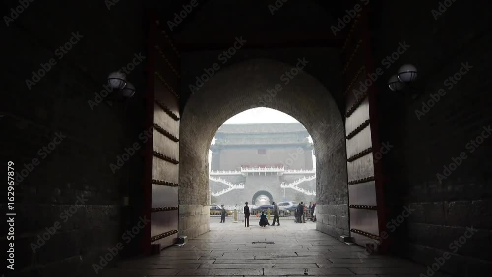 tourist pass ancient city gate tower & arch in beijing china. tourist pass ancient city gate tower & arch in beijing china.