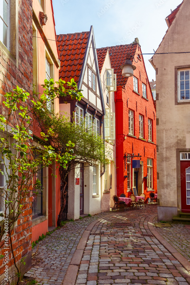 Obraz premium Medieval Bremen street Schnoor with half-timbered houses in the centre of the Hanseatic City of Bremen, Germany