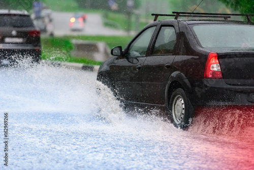car rain puddle splashing water © dbrus
